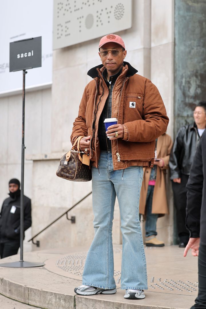 Above, Pharrell Williams attends 2025 Paris Fashion Week. Baldwin cited him as an earlier precedent for the ongoing changes in men's denim silhouettes. 