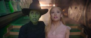 Cynthia Erivo as the green with Elphaba, and Ariana Grande as Galinda in frilly pink.