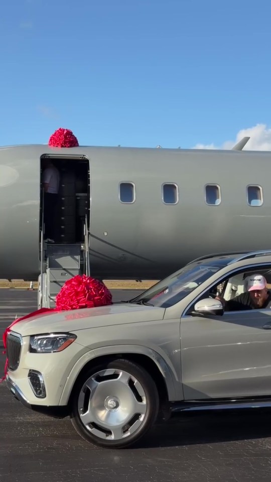 Man in SUV in front of private jet.