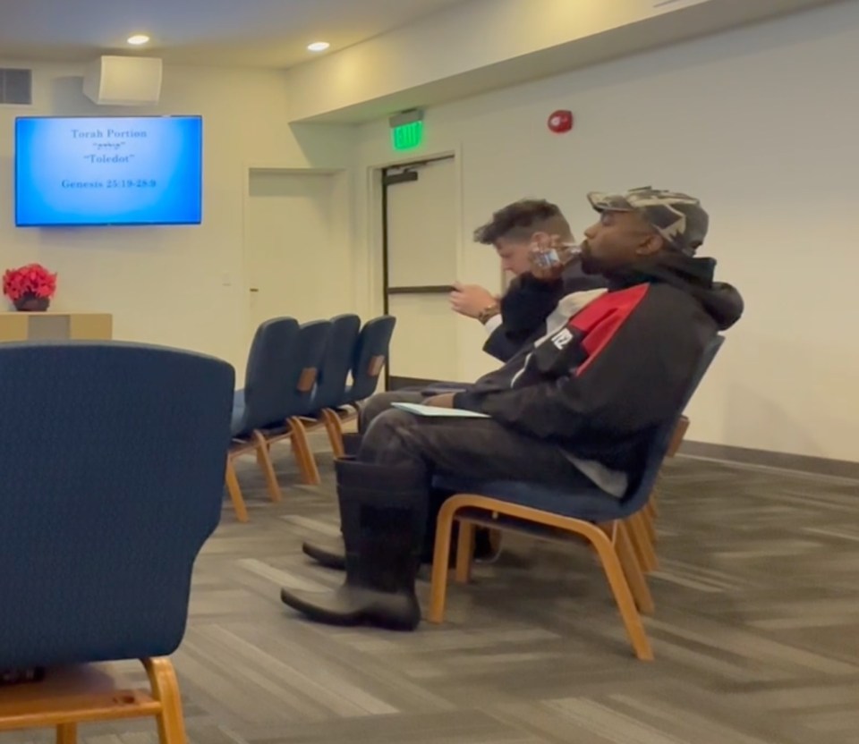 Kanye West sitting in chairs in a room.