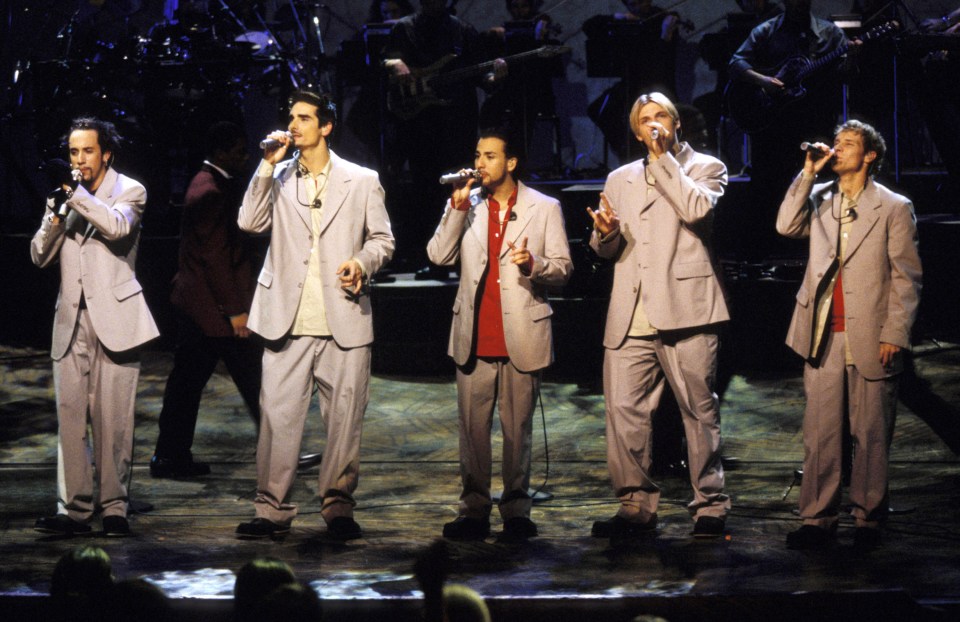 The Backstreet Boys performing on stage.