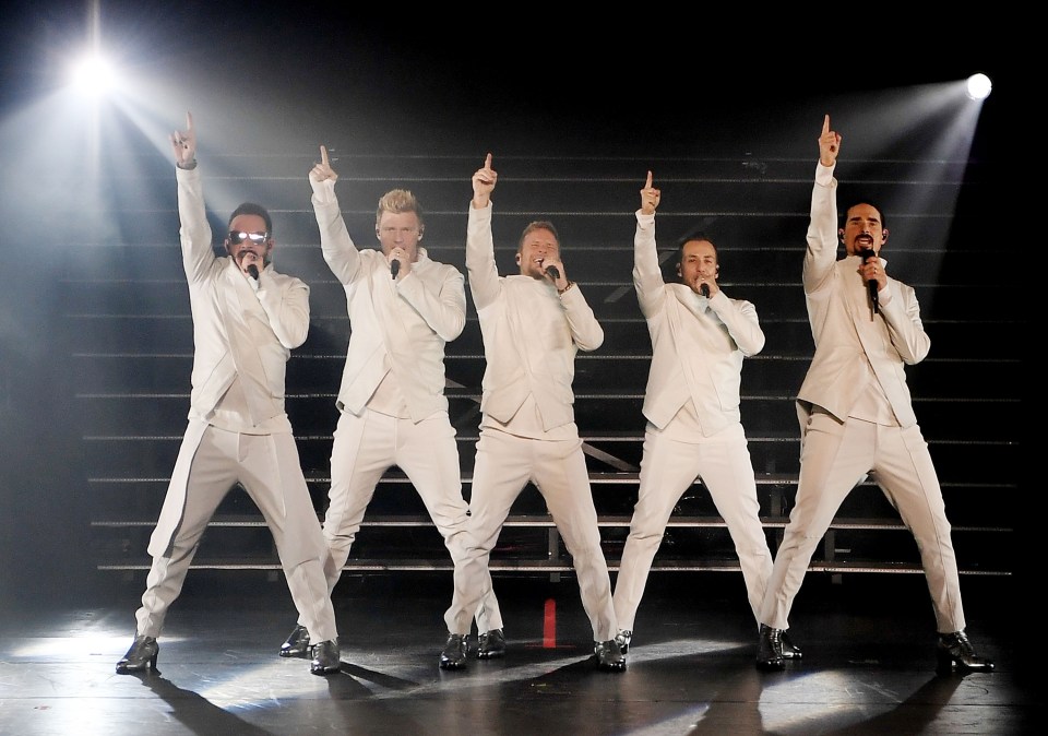 The Backstreet Boys performing on stage.