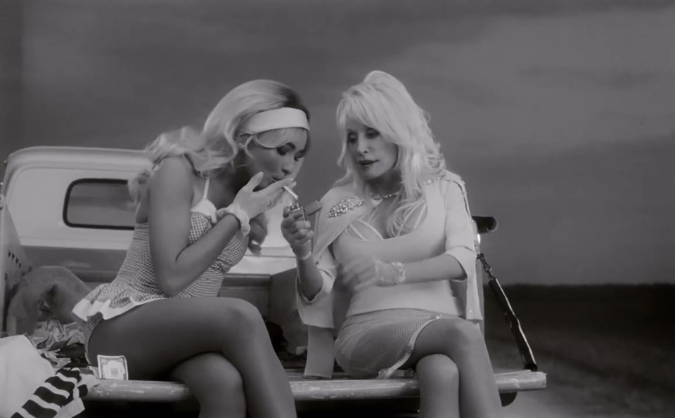 Sabrina Carpenter and Dolly Parton in a black and white music video still.