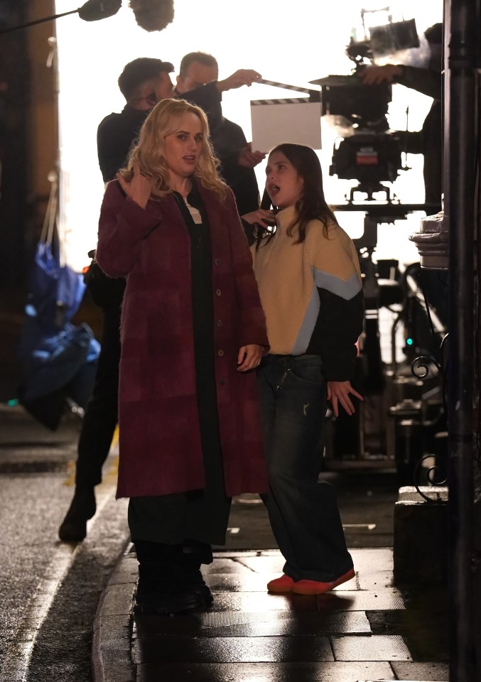 Rebel Wilson and a young girl on a film set.