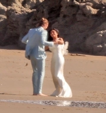 Kim Kardashian and Matthew Noszka on a beach wedding set.