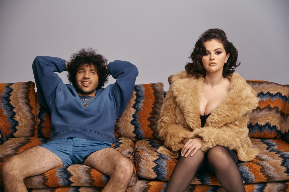 Selena Gomez and Benny Blanco sitting on a couch.