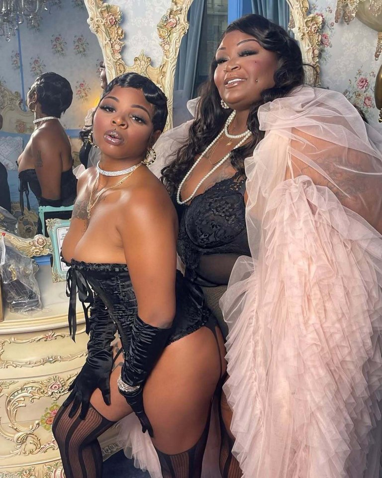 Two women in lingerie and glamorous attire.