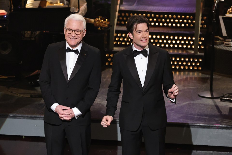 Steve Martin and John Mulaney in tuxedos on stage.