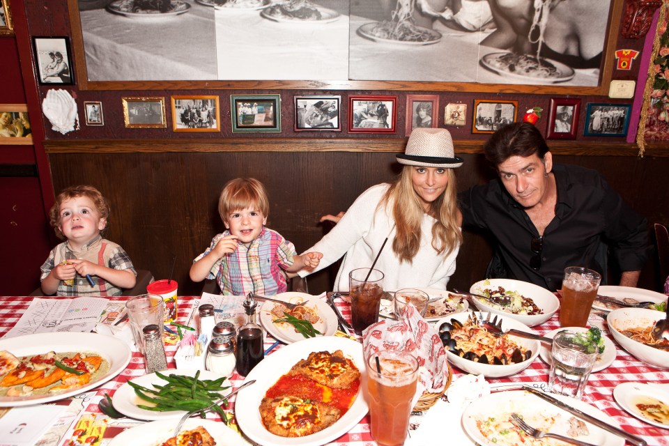 Charlie Sheen, Brooke Mueller, and their two sons celebrating a birthday at a restaurant.