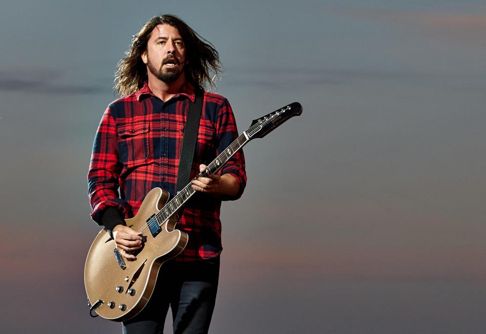 Dave Grohl of the Foo Fighters performing on stage with a guitar.