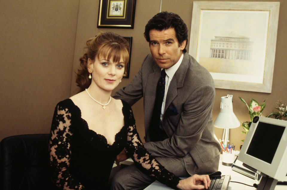 Pierce Brosnan as James Bond and Samantha Bond as Miss Moneypenny in a publicity still for GoldenEye.