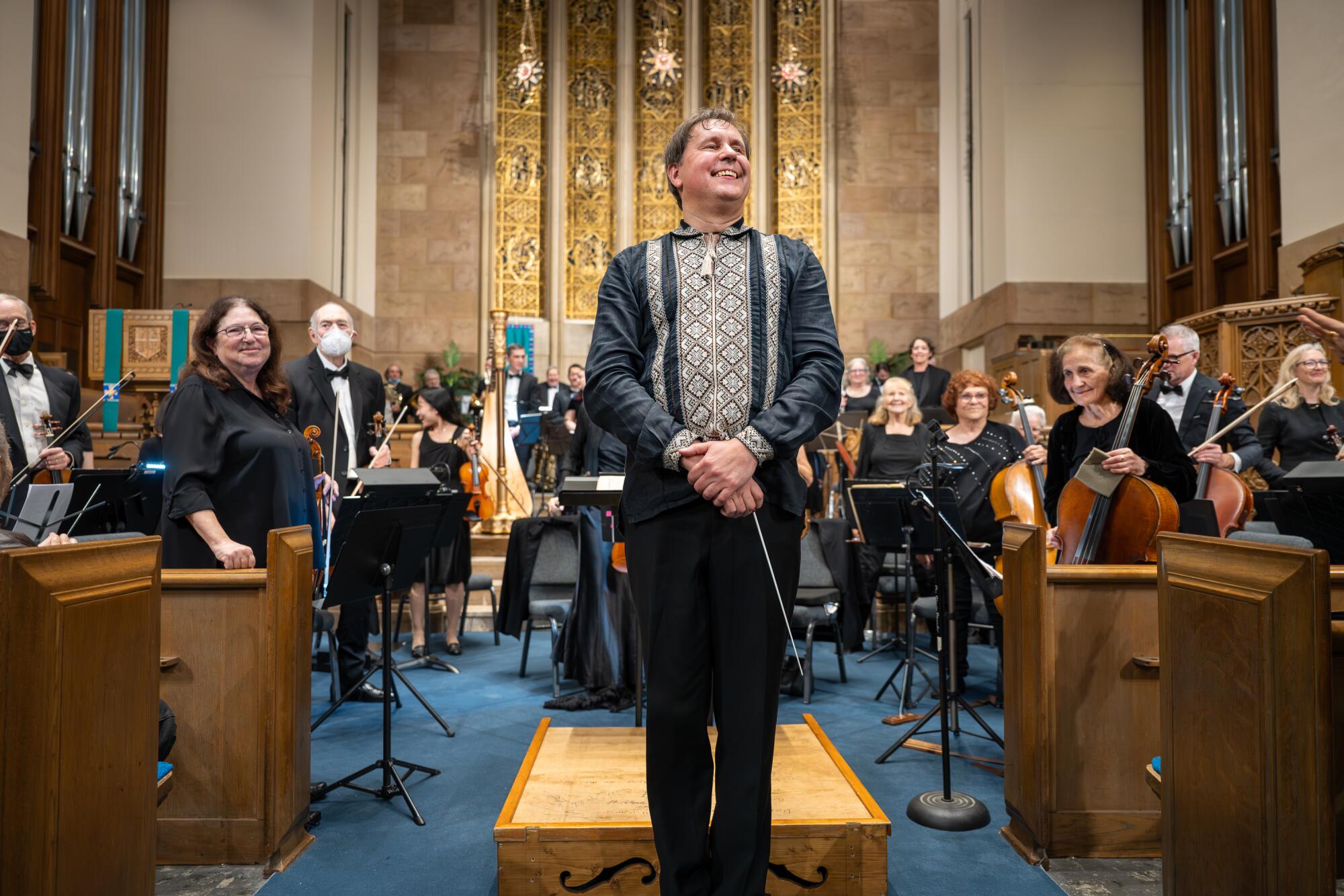 Music director Maxim Kuzin, center, and the Palisades Symphony acknowledge applause after their performance.