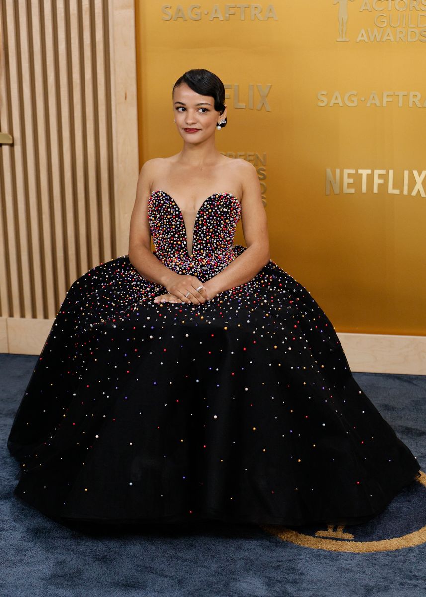 Marissa Bode wearing a black Tony Ward Couture gown adorned with colorful embellishments on the SAG Awards 2025 red carpet.