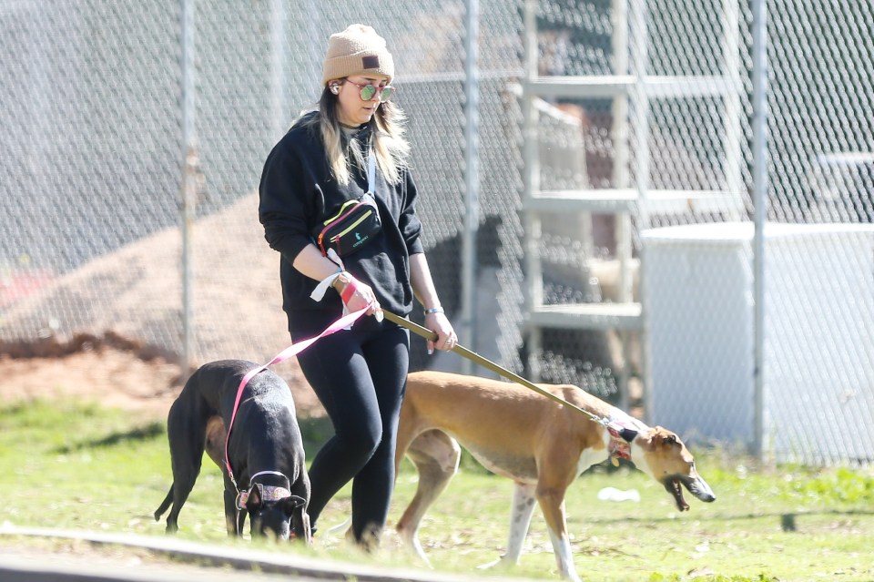 Jenna Marbles walking two dogs.