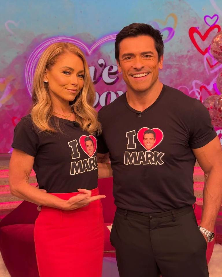 Kelly Ripa and Mark Consuelos wearing "I love Mark" shirts.