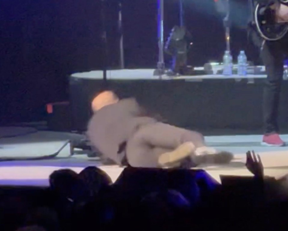 Billy Joel falling on stage during a performance.