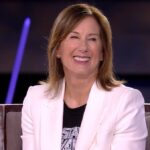 Kathleen Kennedy in a white blazer smiles