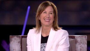 Kathleen Kennedy in a white blazer smiles