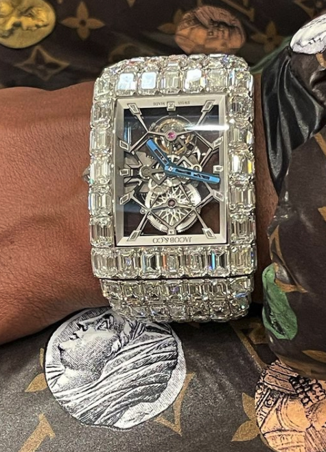 Diamond-encrusted Jacob & Co. watch on a wrist.