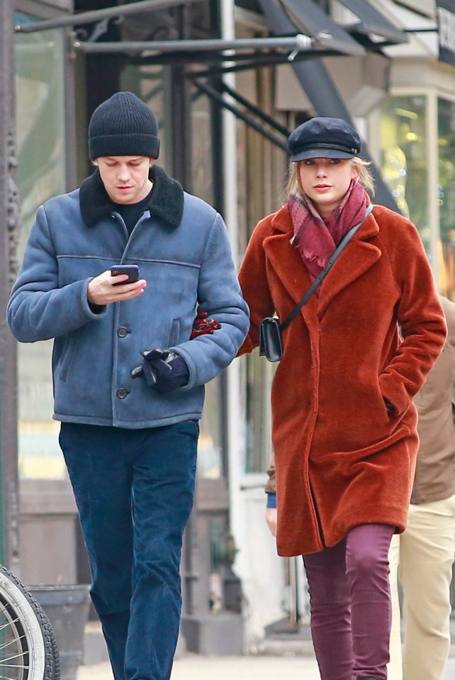 Taylor Swift and Joe Alwyn walking arm in arm in New York City.