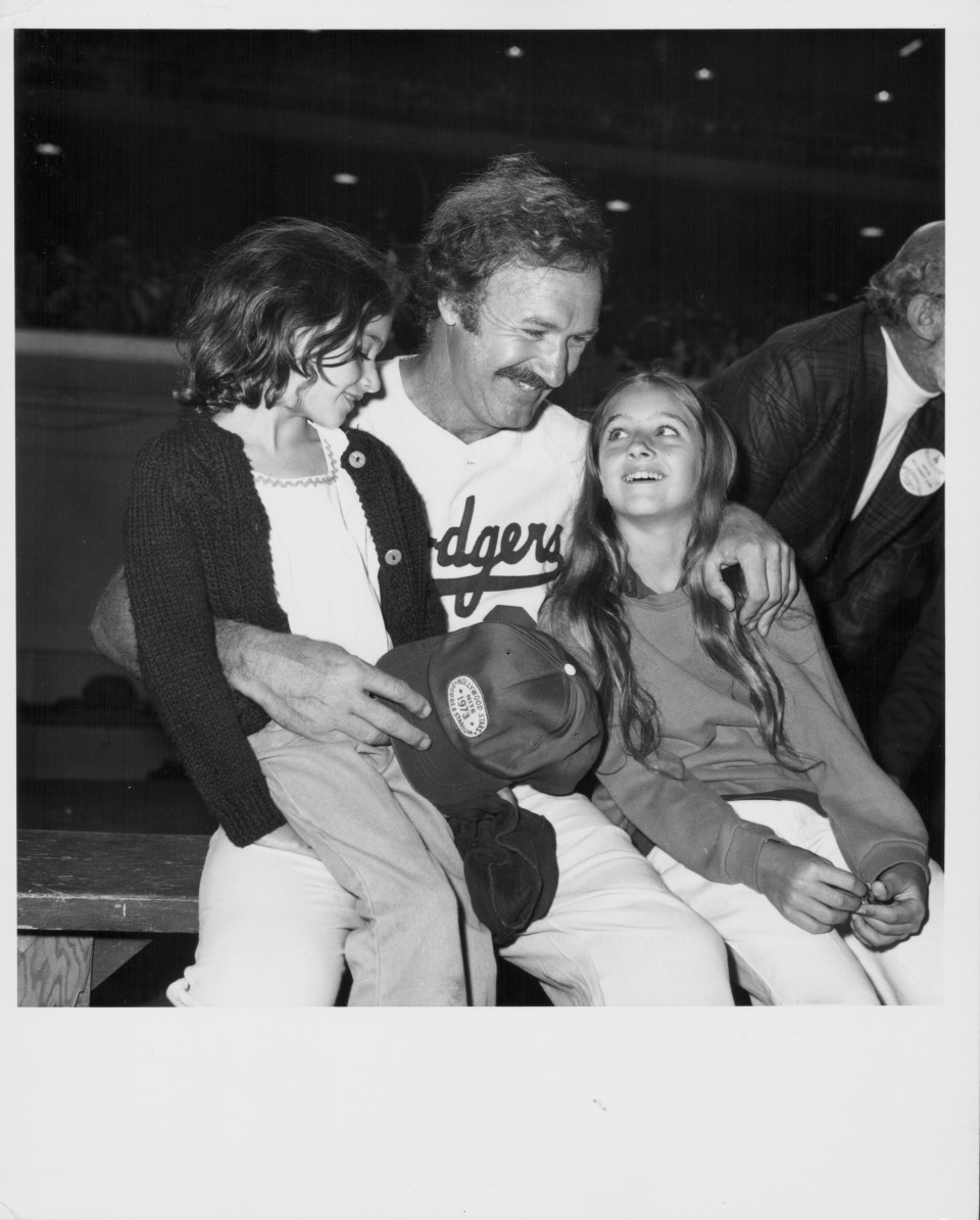 Gene Hackman with his daughters at a celebrity baseball game.