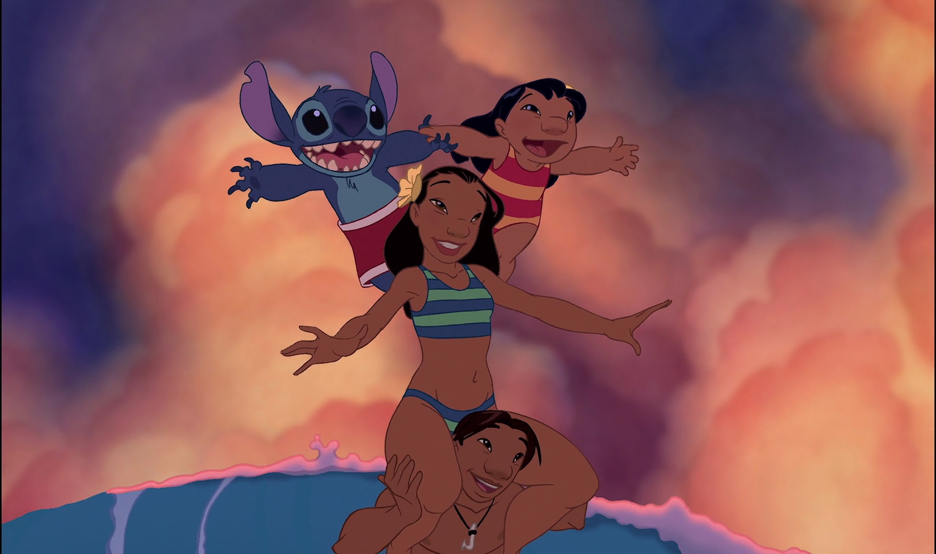 Lilo and Stitch balancing on Nani’s shoulders, while Nani is balanced on David’s shoulders as they all surf in the 2002 cel-animated Lilo & Stitch