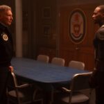 (L-R): Harrison Ford as President Thaddeus Ross and Anthony Mackie as Sam Wilson/Captain America Captain America: Brave New World. They’re looking at each other tensely in a room with a conference table and a military seal on the wall.