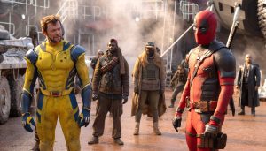 Hugh Jackman as Wolverine looks at Ryan Reynolds as Deadpool, surrounded by enemy soldiers in a scene from 'Deadpool & Wolverine'