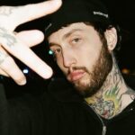 A photo of FaZe Banks flashing the FaZe symbol.