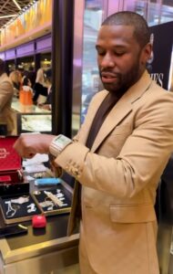 Floyd Mayweather showing off a diamond-encrusted watch.