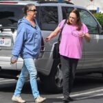 Elizabeth and Leslie Hackman walking in a parking lot.