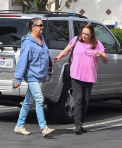 Elizabeth and Leslie Hackman walking in a parking lot.