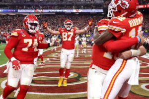 LAS VEGAS, NEVADA - FEBRUARY 11: Mecole Hardman Jr. #12 of the Kansas City Chiefs celebrates with Patrick Mahomes #15 and Travis Kelce #87 and teammates after catching the game-winning touchdown pass to defeat the San Francisco 49ers 25-22 during Super Bowl LVIII at Allegiant Stadium on February 11, 2024 in Las Vegas, Nevada. (Photo by Ezra Shaw/Getty Images)