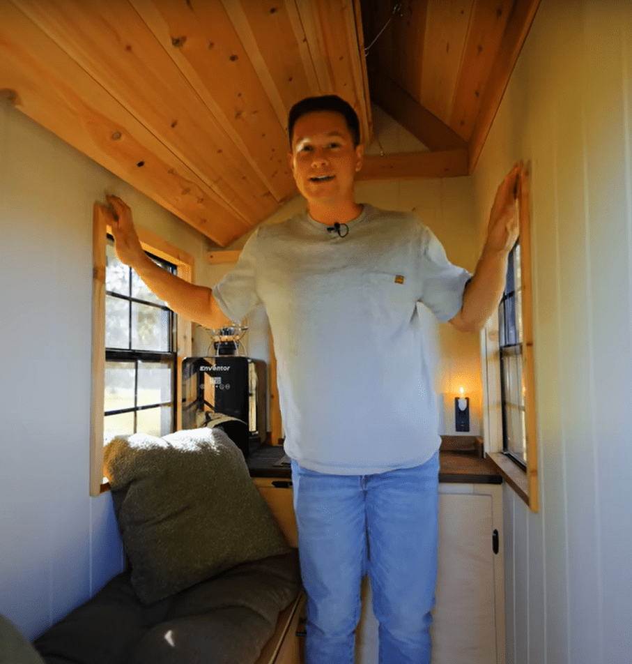 Man standing in a tiny house.