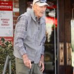 Gene Hackman and his wife leaving a restaurant.