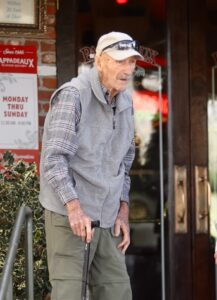 Gene Hackman and his wife leaving a restaurant.