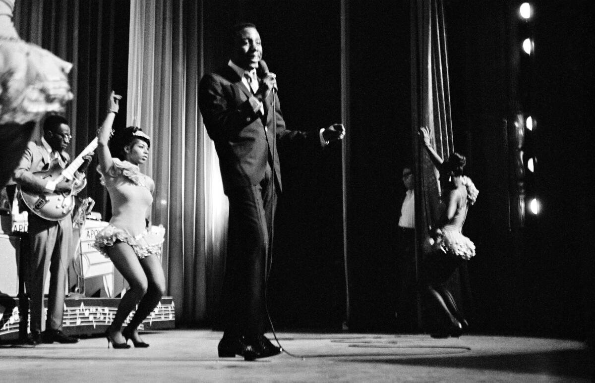 American soul singer Jerry Butler performs with Betty Everett and The Impressions at the Apollo Theatre circa 1965.