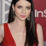 Headshot of Michelle Trachtenberg in a red dress.