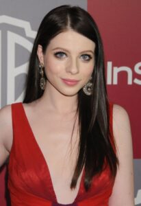 Headshot of Michelle Trachtenberg in a red dress.