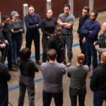 Xavier (Sterling K. Brown) stands in the middle of a circle of secret service agents as they prepare to revolt in Paradise