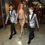 Shakira walking backstage at the Grammy Awards with her two sons.