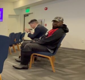 Kanye West sitting in a chair.