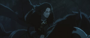 A dark-haired rider on a dark horse scowls while riding through the dark in a dark image from Lord of the Rings: The War of the Rohirrim