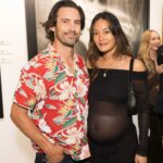 Milo Ventimiglia and Jarah Mariano at an art exhibition.