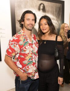 Milo Ventimiglia and Jarah Mariano at an art exhibition.