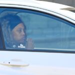 Tyra Banks eating in a car.