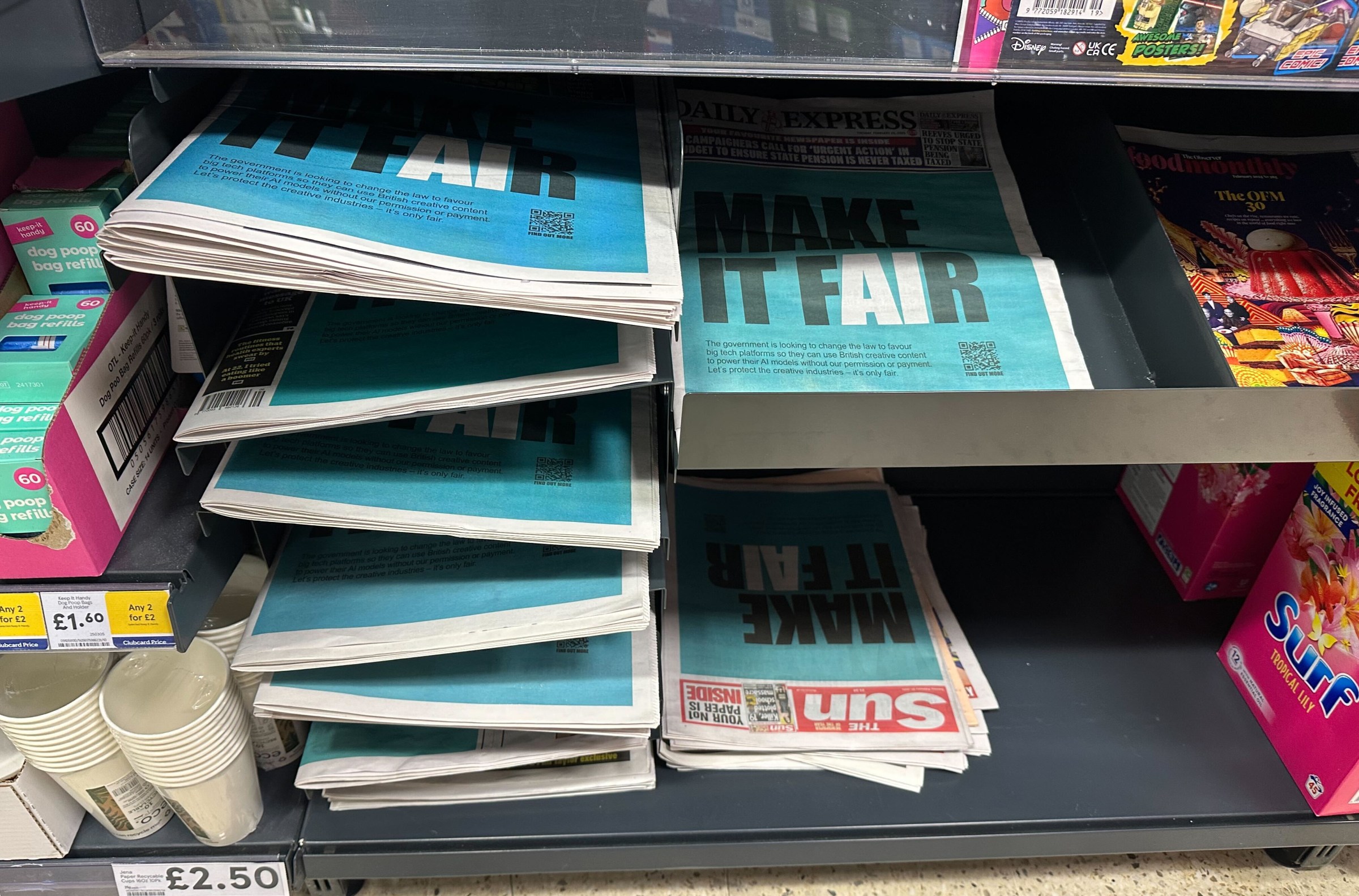 A photograph of several newspapers all depicting the same “make it fair” campaign imagery.