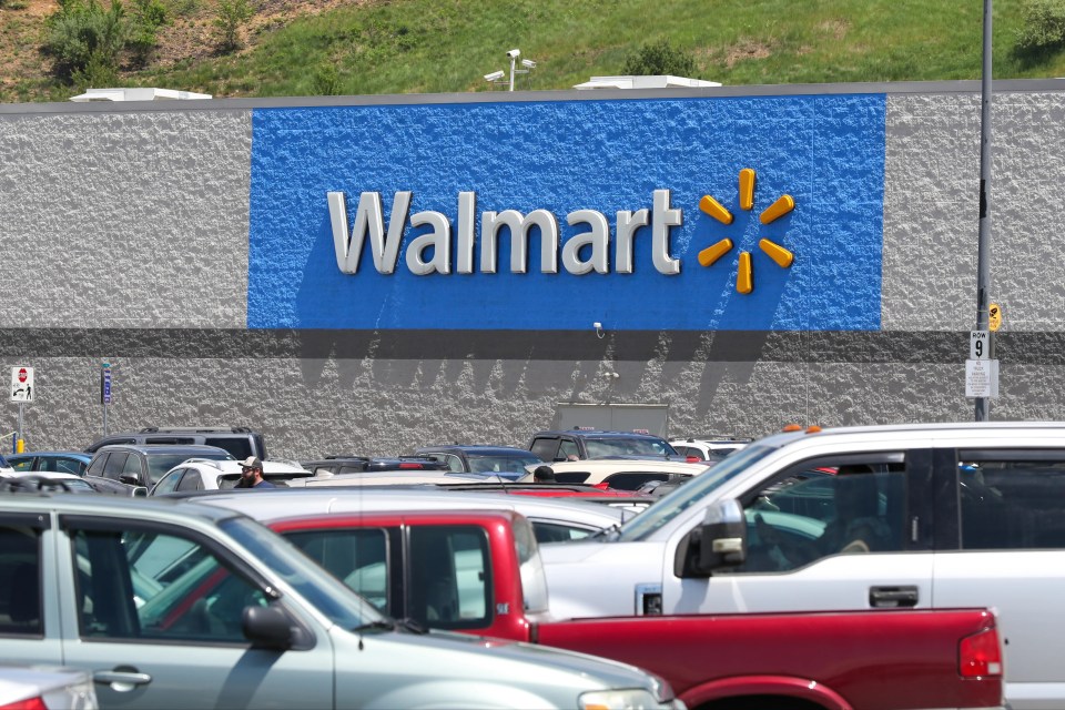 A Walmart store with a full parking lot.