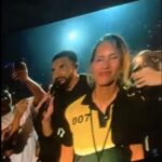 Screenshot of Drake and a woman on stage.