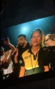 Screenshot of Drake and a woman on stage.